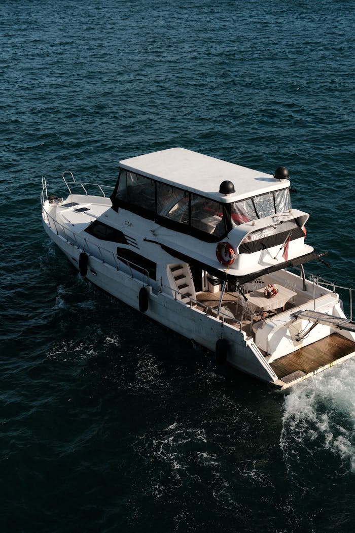 A modern yacht navigating the deep blue ocean waters with a peaceful and serene ambiance.